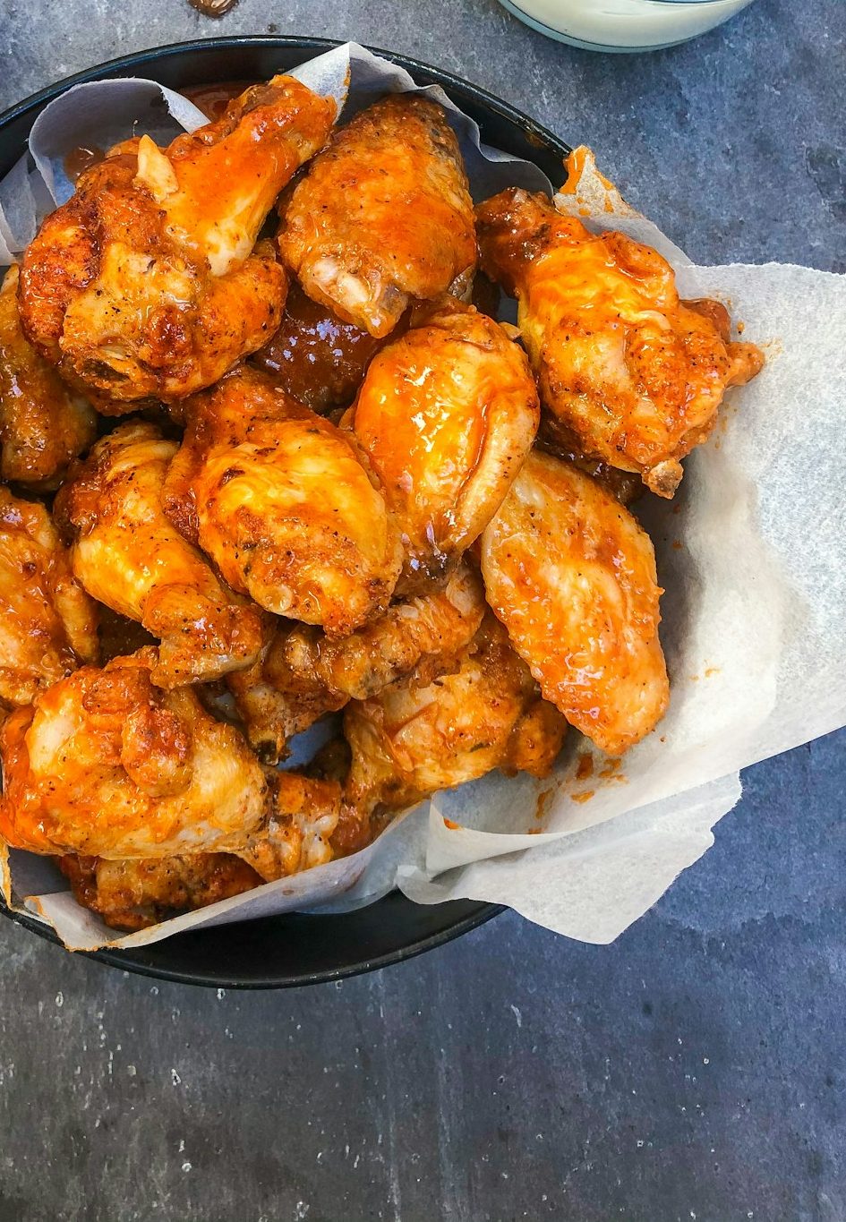 Buffalo wings in a paper-lined basket