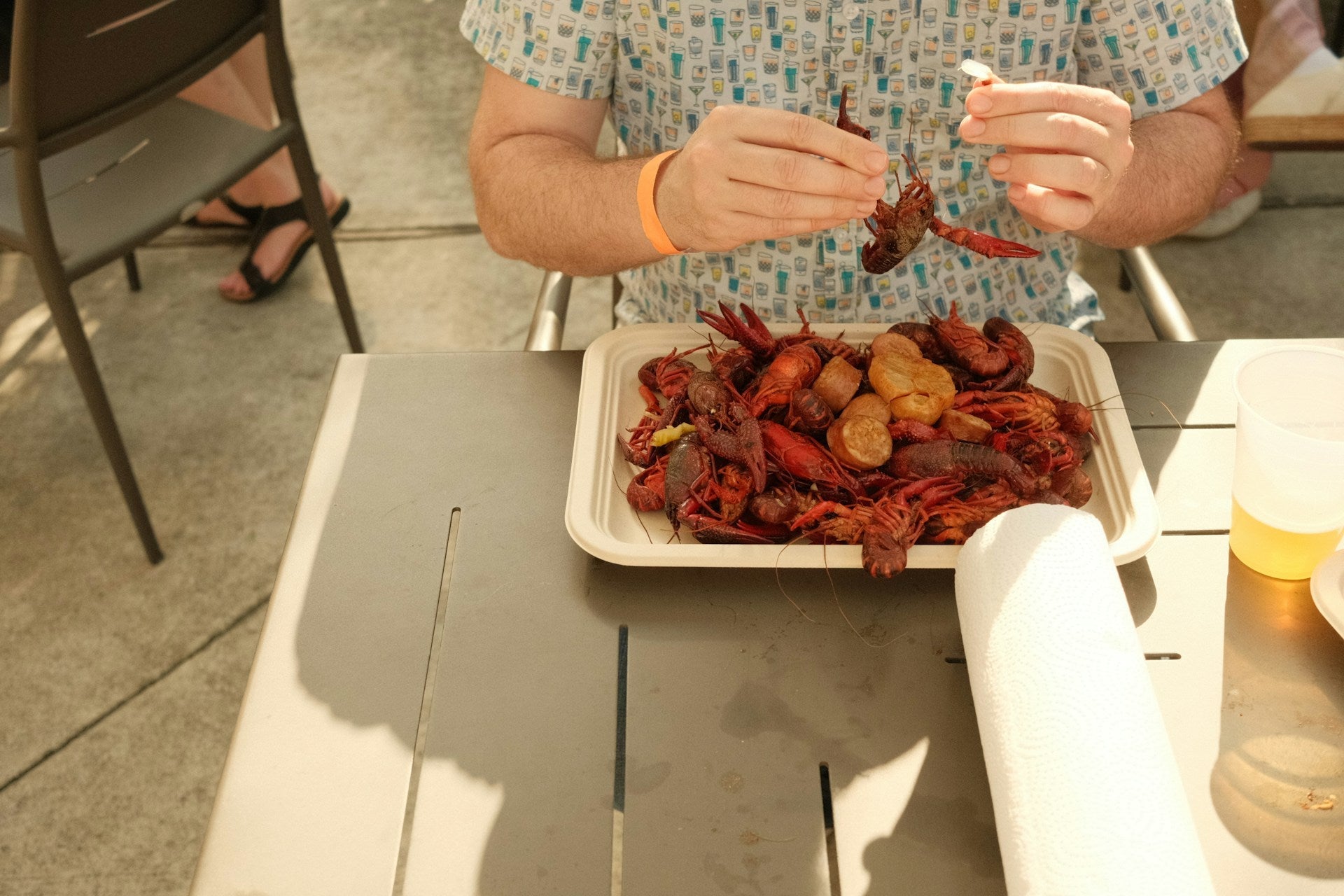 man eating boiled crawfish prepared with concession equipment at a state fair