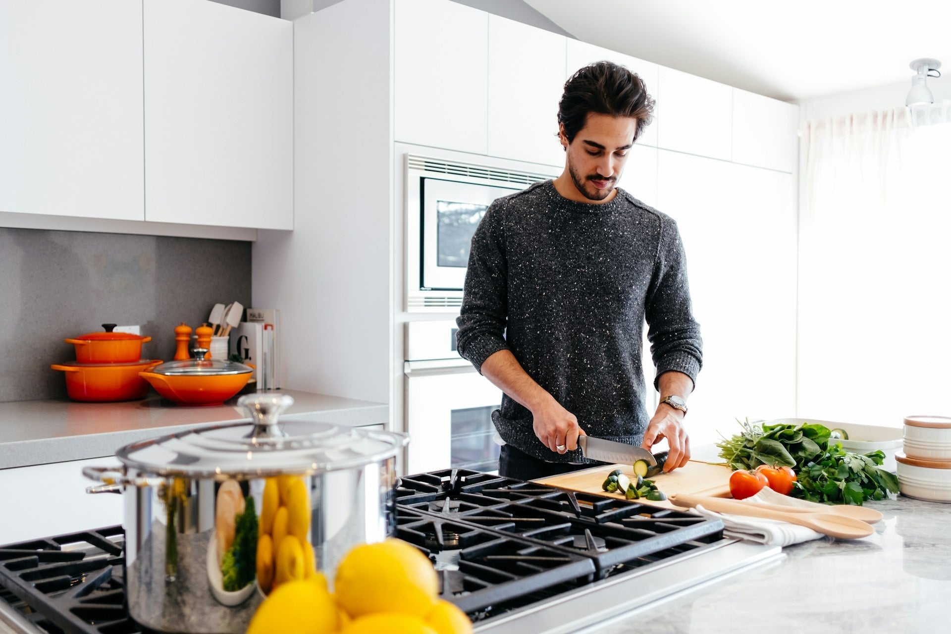 a man chopping vegetables in a kitchen