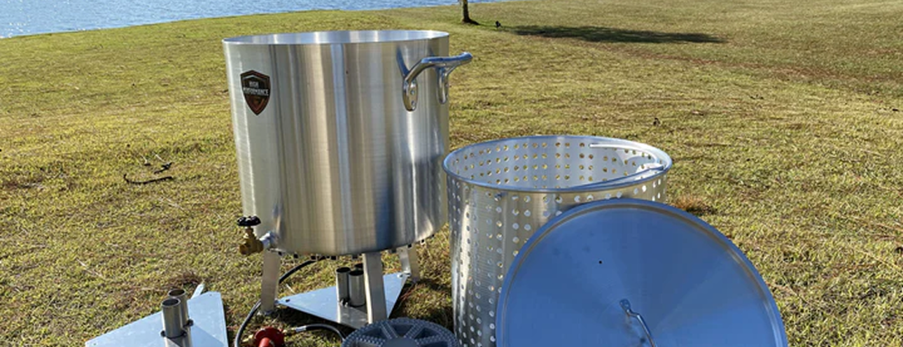 The High Performance Cookers 120 Quart Powered Seafood/Crawfish Cooker by a lake