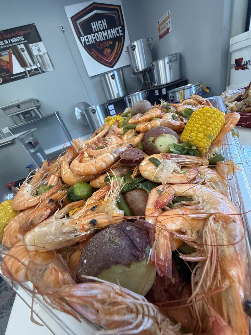 A shrimp boil spread in the HPC showroom in Covington, with the cookers on the racks behind it
