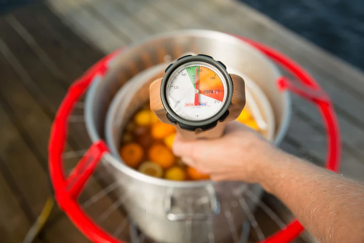 The Boil Boss crawfish boil paddle sensing the temperature of a seafood boil