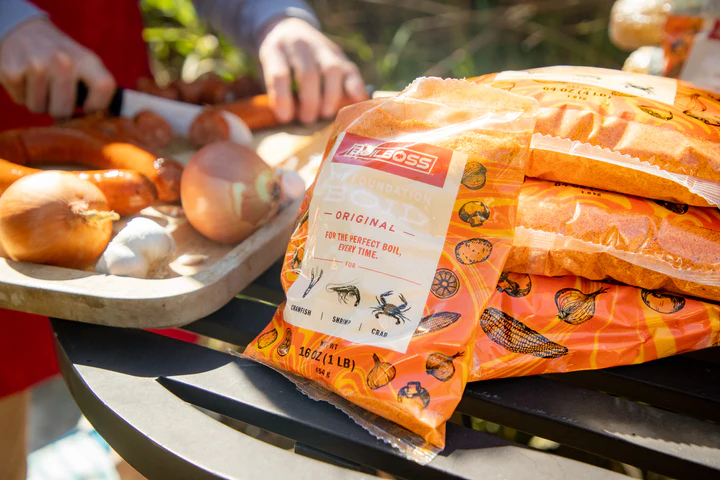 Person preparing food for a boil next seafood seasoning bags