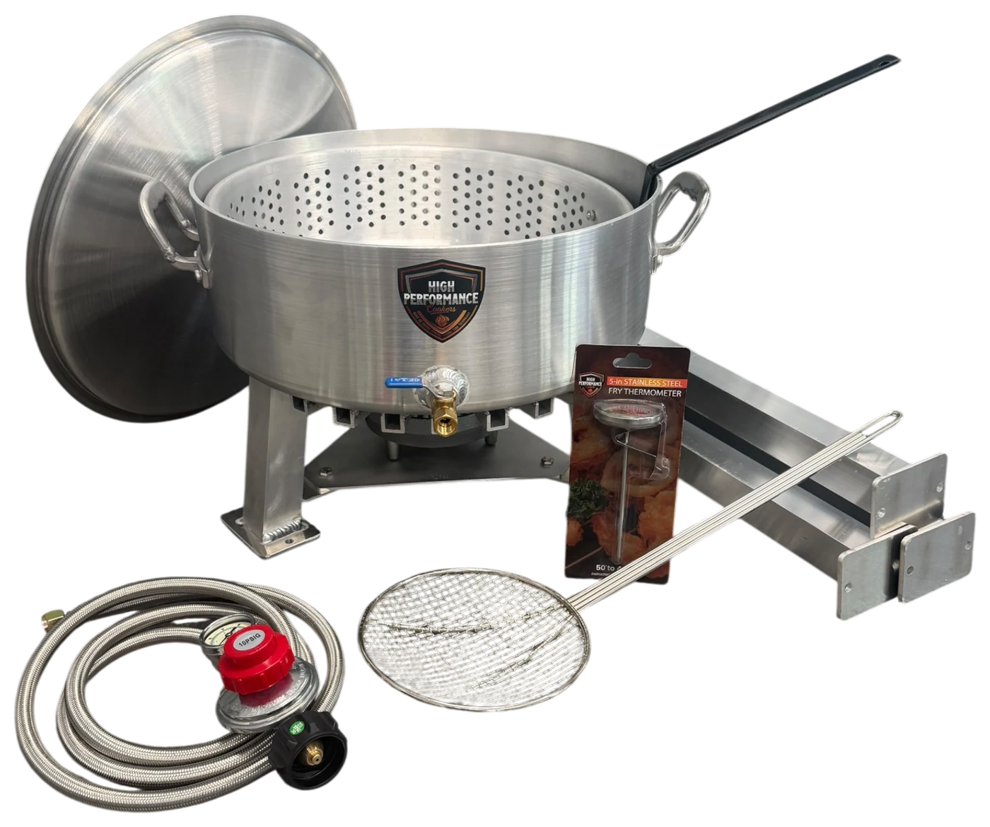 Tailgate Fry Kit laid out: 18 QT powered fryer, basket, leg extensions, 5-inch fry thermometer, skimmer, hose and regulator